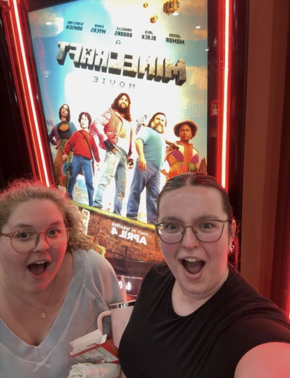 us in front of movie poster.